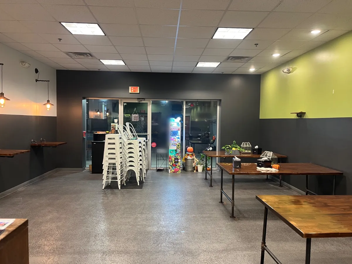 Shop walls after painting, charcoal front and lower walls under a lime green upper wall
